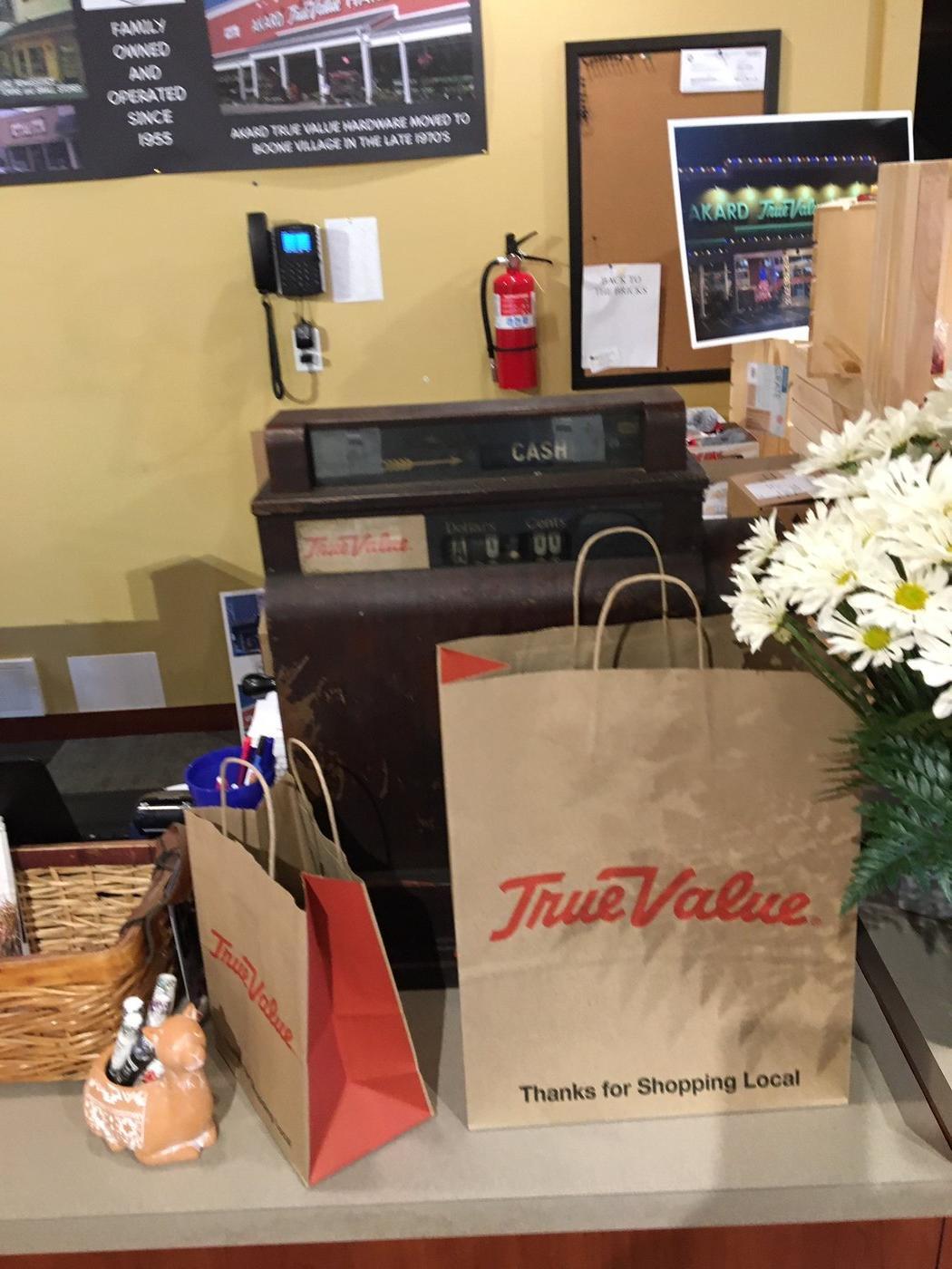 At the checkout counter is an antique cash register from an old True Value store that an employee had in storage.