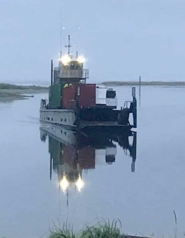 Tosh Parker’s 96-foot barge, dubbed the Claim Jumper, heads to shore with its valuable cargo.