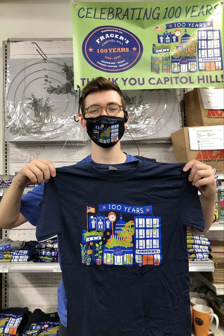 Frager’s Hardware Turns 100! 2 Theodore Ammon shows off the 100th anniversary shirts for sale.
