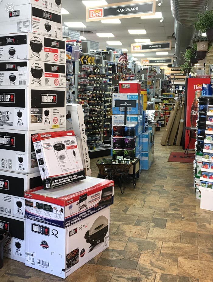 Weber grills are stacked high near the front entrance.