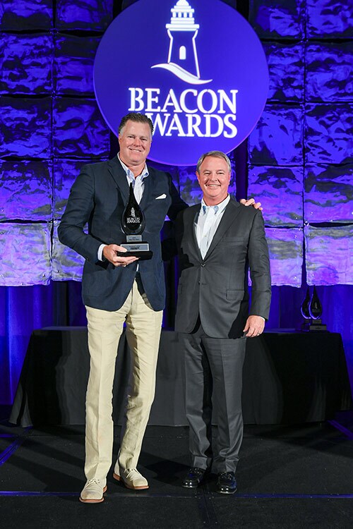 Dirk Koopman (left), CEO of Koopman Lumber and third-generation owner, accepts the Beacon Award for Best new store alongside Orgill CEO Boyden Moore. 