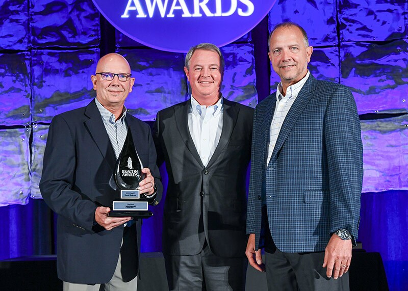 From left, Buchheit vice president of merchandising Doug Buchheit, Orgill CEO Boyden Moore, and Buchheit executive vice president Jon Buchheit accept the 2024 Retail Beacon Award.