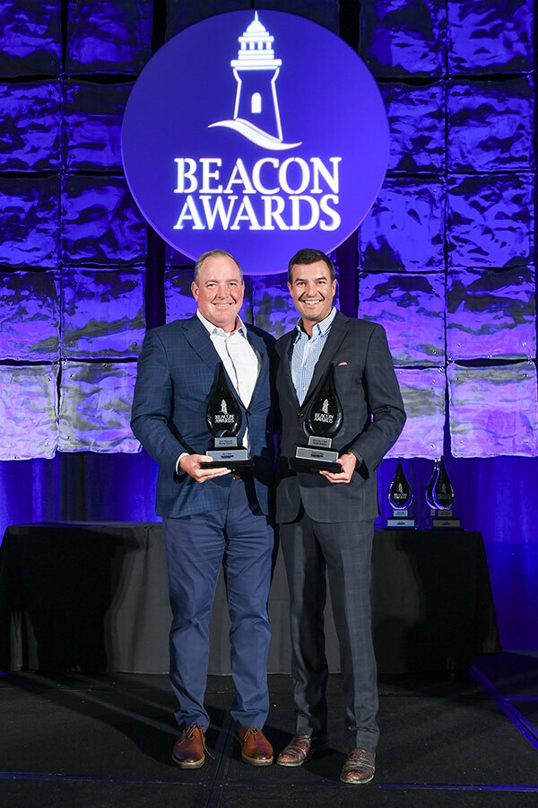 Nation’s Best CEO Chris Miller (right) accepts the Retail Beacon Award with Dent Johnson, Do it Best vice president of merchandising.