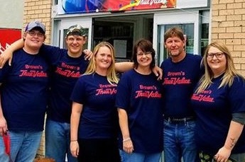 Lori Colgan (third from right), owner of Brown’s True Value Hardware in Atwood, Kan., bought her store when she was 25 and single, later got married and raised her children as “True Value kids.”