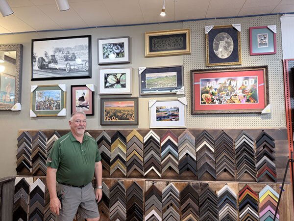 Rows of completed projects line the wall behind Larry Myers, each one ready for pickup. It’s a daily reminder of the work that keeps him motivated—seeing what customers bring in and knowing it’s about to head back into a home or business with lasting meaning. 